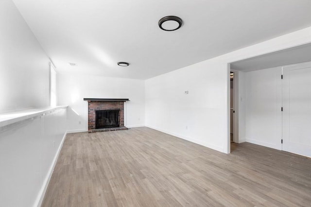 11 Adams St, Foxboro, MA 02035 - unfurnished living room featuring baseboards, light wood-style flooring, and a fireplace