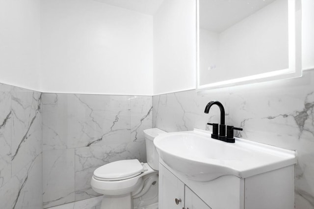 11 Adams St, Foxboro, MA 02035 - half bath with vanity, wainscoting, toilet, and tile walls