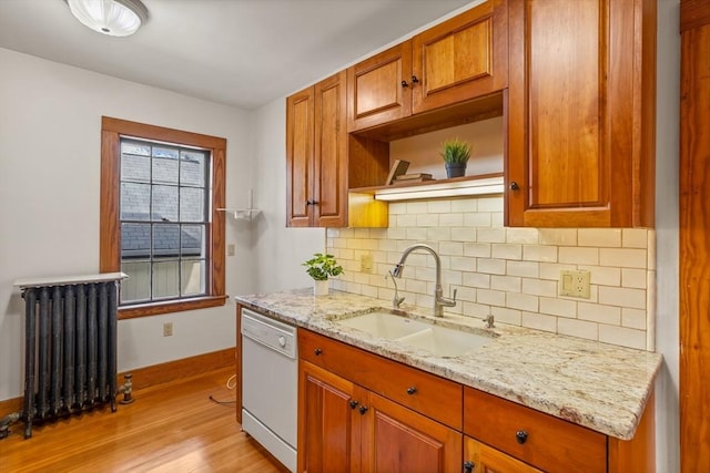 301 Old Billerica Rd, Bedford, MA 01730 - kitchen with radiator, white dishwasher, a sink, baseboards, and light wood finished floors