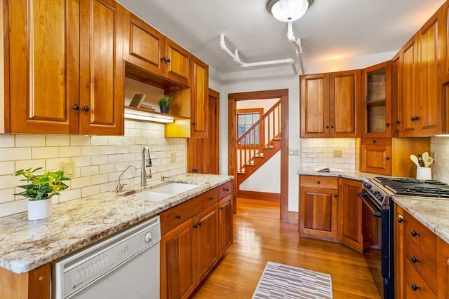 301 Old Billerica Rd, Bedford, MA 01730 - kitchen with white dishwasher, range with gas cooktop, a sink, light wood finished floors, and light stone countertops