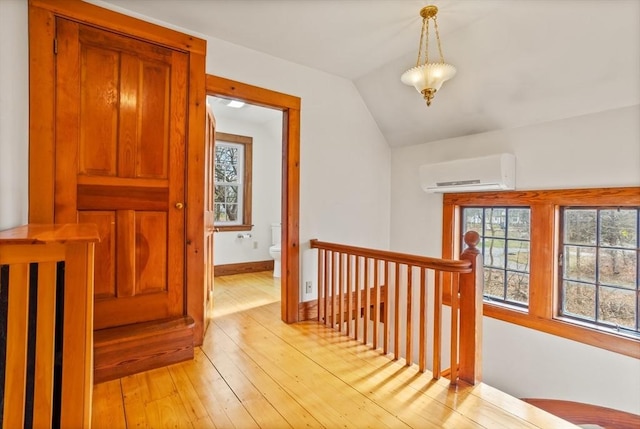 301 Old Billerica Rd, Bedford, MA 01730 - hall featuring a wall mounted AC, an upstairs landing, light wood-style flooring, plenty of natural light, and vaulted ceiling