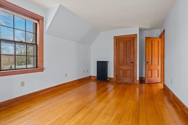 301 Old Billerica Rd, Bedford, MA 01730 - additional living space featuring radiator, light wood-style flooring, lofted ceiling, and baseboards