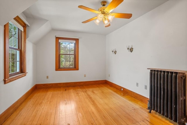 301 Old Billerica Rd, Bedford, MA 01730 - additional living space featuring radiator heating unit, light wood-style flooring, vaulted ceiling, baseboards, and ceiling fan