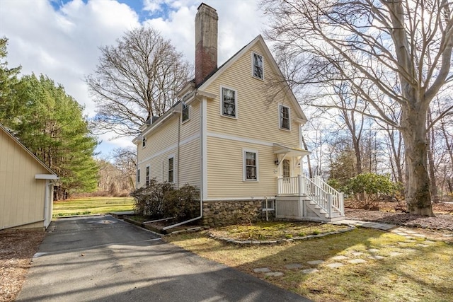 301 Old Billerica Rd, Bedford, MA 01730 - view of side of property with a chimney and stone siding