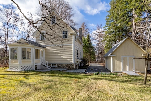301 Old Billerica Rd, Bedford, MA 01730 - view of side of home featuring a chimney, an outbuilding, a lawn, and entry steps