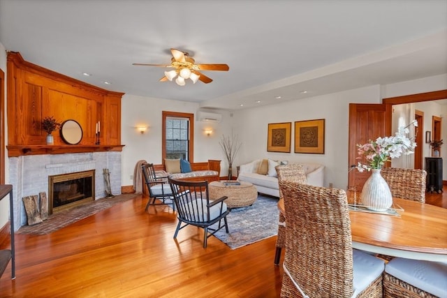 301 Old Billerica Rd, Bedford, MA 01730 - dining space with ceiling fan, light wood-style floors, a brick fireplace, a wall unit AC, and recessed lighting