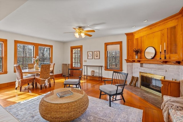 301 Old Billerica Rd, Bedford, MA 01730 - living area with a fireplace, light wood-type flooring, a ceiling fan, and baseboards