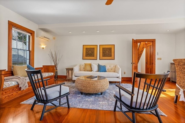 301 Old Billerica Rd, Bedford, MA 01730 - living room with radiator heating unit, a wall mounted AC, wood finished floors, recessed lighting, and baseboards