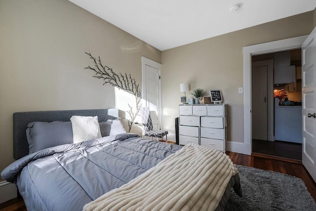 bedroom with dark hardwood / wood-style flooring