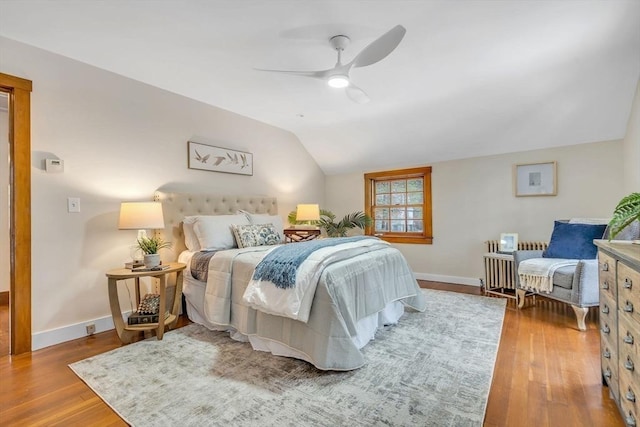 bedroom featuring vaulted ceiling, wood finished floors, a ceiling fan, and baseboards