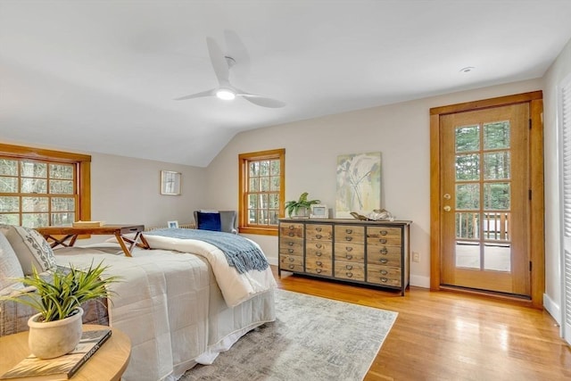 bedroom with lofted ceiling, light wood-style flooring, a ceiling fan, baseboards, and access to outside