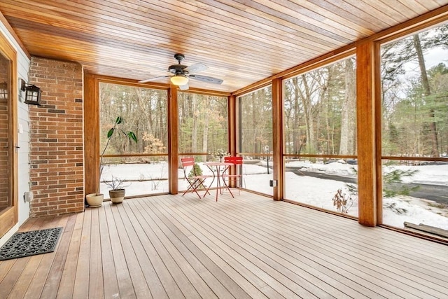 unfurnished sunroom with wooden ceiling and a ceiling fan