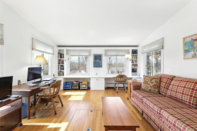 living room featuring light wood-style flooring and baseboard heating