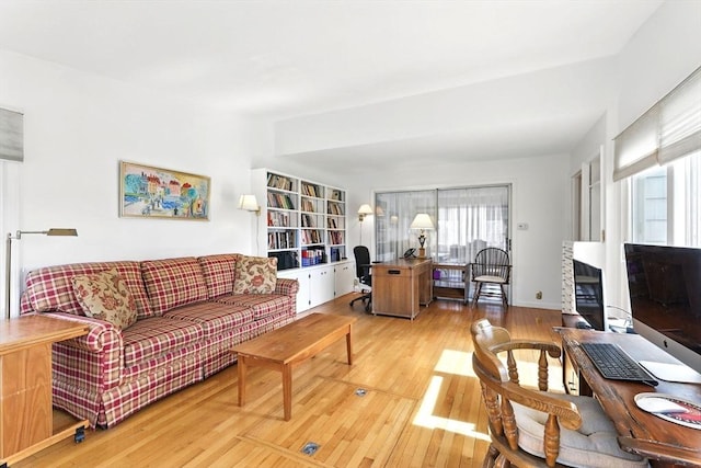 living area with plenty of natural light and light wood-type flooring