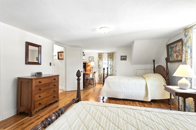 bedroom with baseboards and wood finished floors