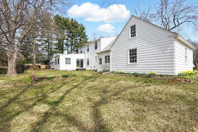 back of house featuring a lawn