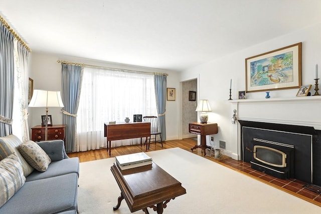 living area with baseboards and wood finished floors