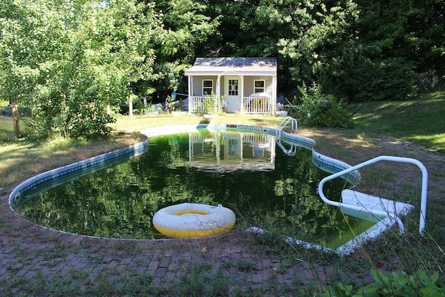 surrounding community with a pool and an outdoor structure