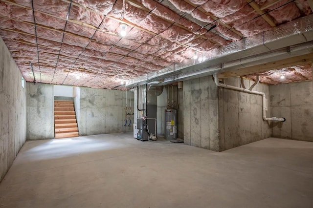 72 N Mast St Unit 1, Goffstown, NH 03045 - unfinished basement featuring electric water heater, stairway, and heating unit