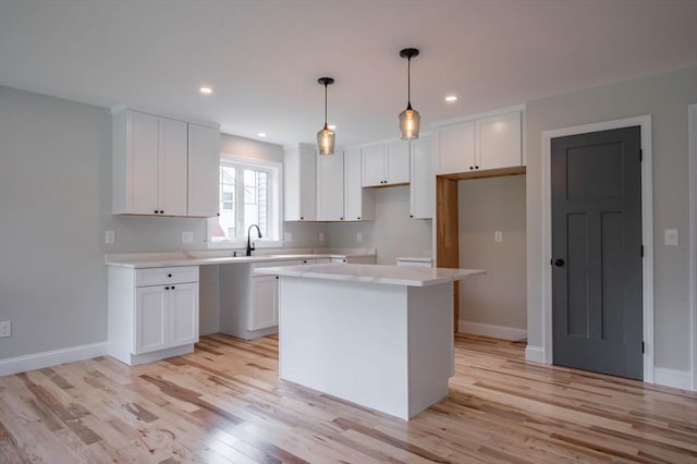 72 N Mast St Unit 1, Goffstown, NH 03045 - kitchen featuring a center island, light wood-style flooring, white cabinets, recessed lighting, and decorative light fixtures