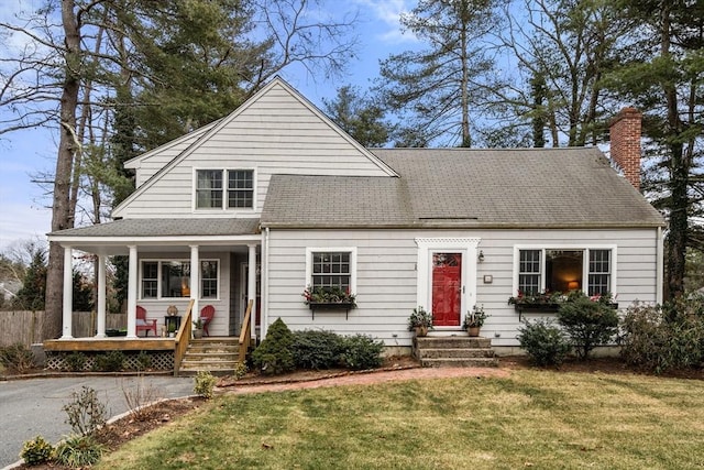 view of front of house with a porch and a front lawn