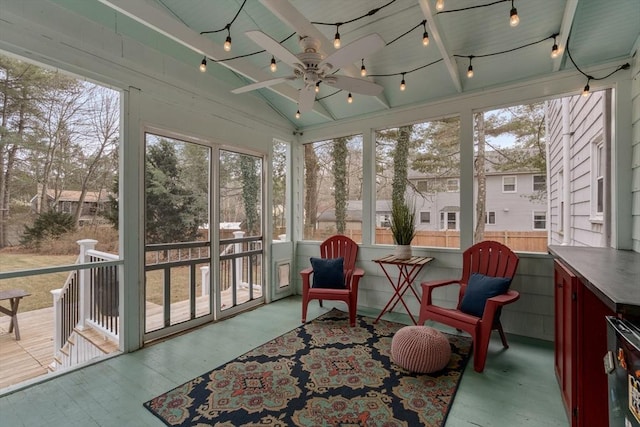 sunroom featuring a wealth of natural light, ceiling fan, and lofted ceiling