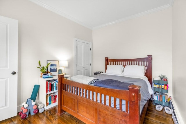 390 Riverway Unit 24, Boston, MA 02115 - bedroom with crown molding, a baseboard heating unit, wood finished floors, and a closet