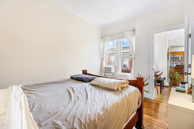 390 Riverway Unit 24, Boston, MA 02115 - bedroom with wood finished floors, crown molding, and cooling unit