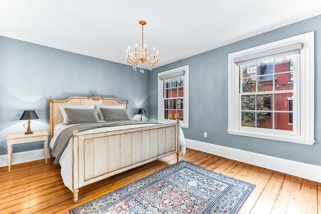 bedroom featuring hardwood / wood-style floors and a notable chandelier