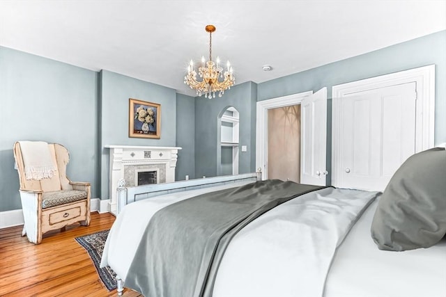 bedroom featuring hardwood / wood-style flooring and a notable chandelier