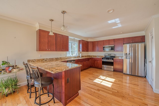 kitchen featuring light hardwood / wood-style flooring, hanging light fixtures, kitchen peninsula, stainless steel appliances, and crown molding