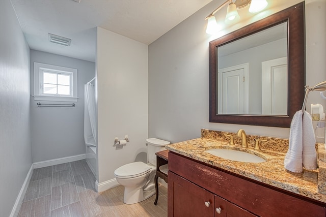 bathroom featuring vanity and toilet