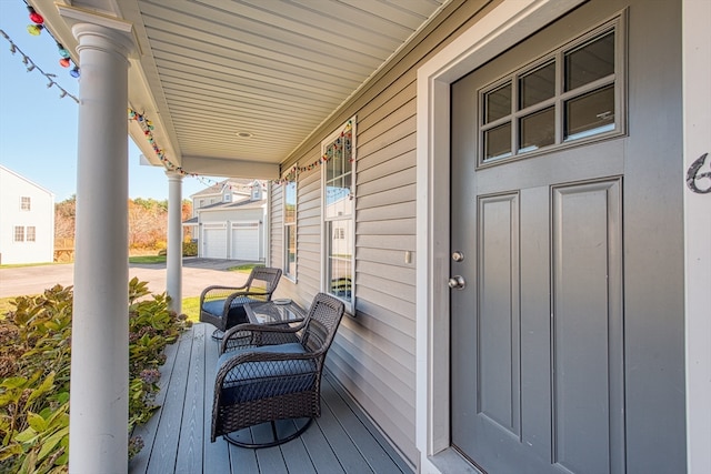 deck with a porch and a garage