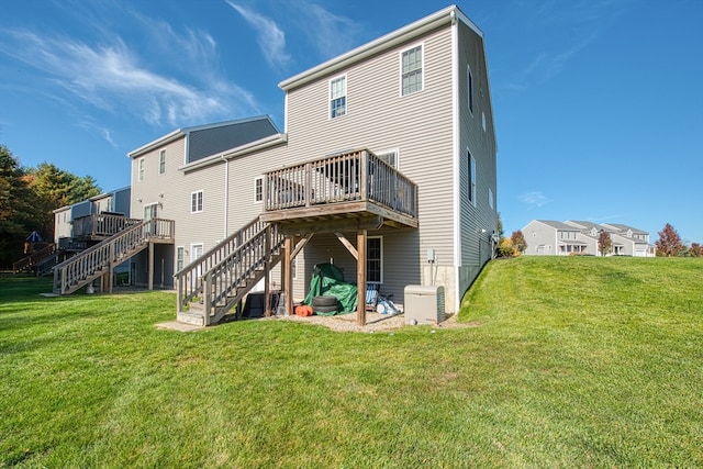 back of house with a deck and a lawn