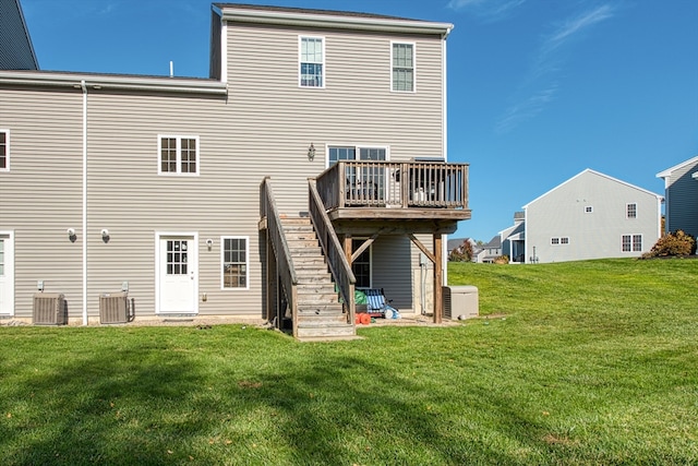 back of property with cooling unit, a deck, and a lawn