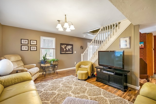 living room featuring wood-type flooring and an inviting chandelier