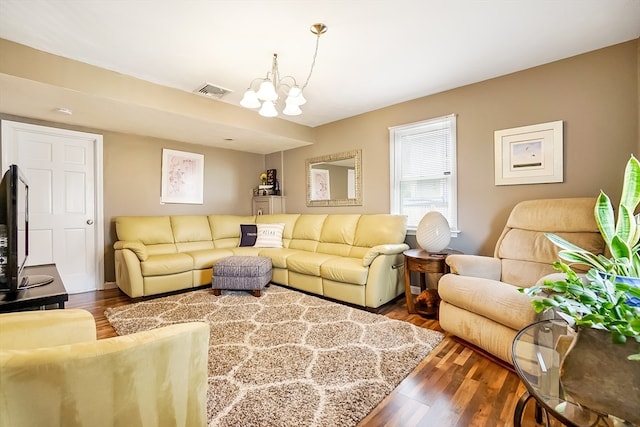 living room with an inviting chandelier and dark hardwood / wood-style floors