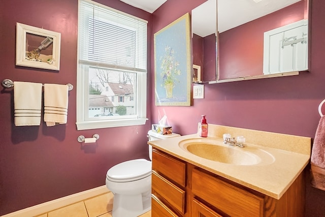 bathroom with vanity, toilet, and tile patterned flooring