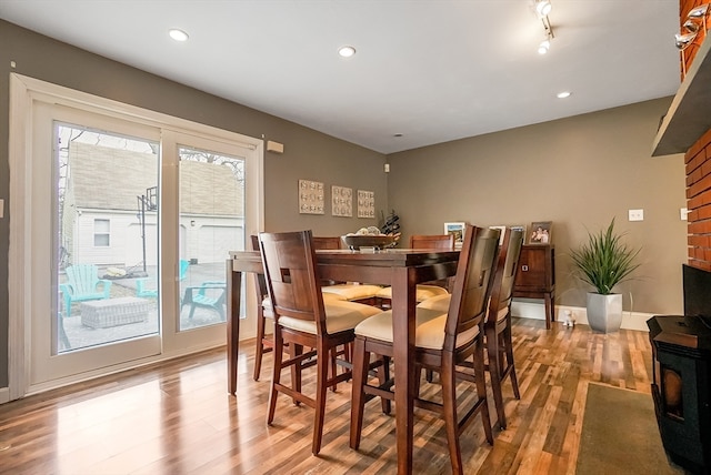 dining room with hardwood / wood-style floors and a healthy amount of sunlight