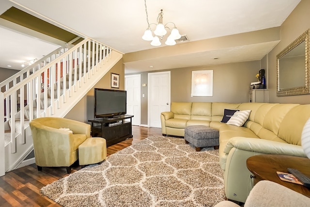 living room with dark hardwood / wood-style floors and a notable chandelier