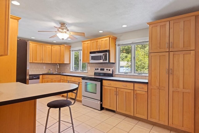 156 Patterson St, Attleboro, MA 02703 - kitchen with stainless steel appliances, a sink, tasteful backsplash, recessed lighting, and light tile patterned floors