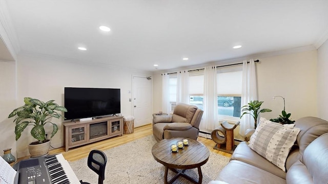 living room with recessed lighting, light wood-type flooring, baseboard heating, and ornamental molding