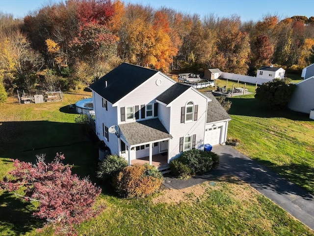 drone / aerial view with a wooded view