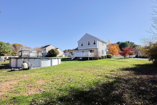 view of yard featuring a covered pool and a deck