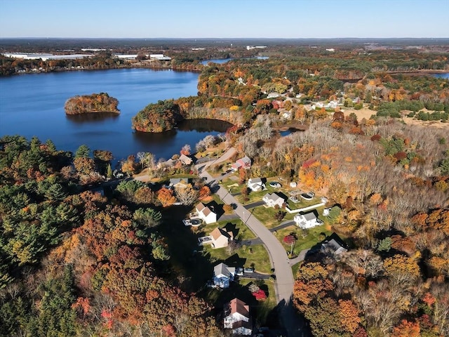 drone / aerial view featuring a water view and a forest view