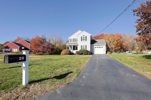 view of front of property with driveway, an attached garage, and a front yard