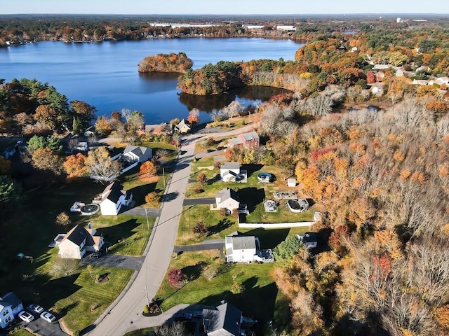 drone / aerial view featuring a water view and a forest view