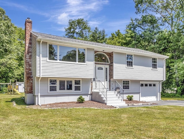 4 Gary Rd, Norton, MA 02766 - raised ranch with asphalt driveway, a chimney, a front lawn, and an attached garage