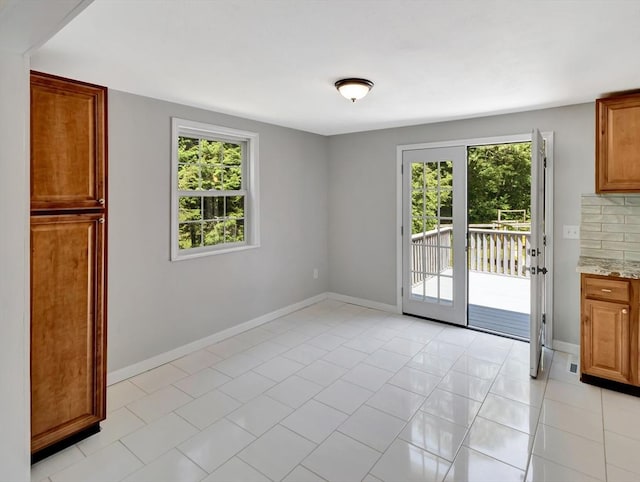 4 Gary Rd, Norton, MA 02766 - unfurnished dining area featuring light tile patterned flooring and baseboards