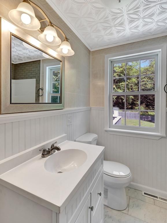 4 Gary Rd, Norton, MA 02766 - bathroom with vanity, marble look tile flooring, and ornamental molding